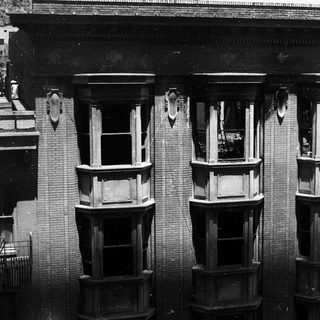 Historic building facade with bay windows.