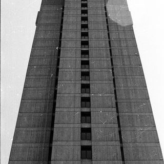 Tall modern skyscraper with dark glass facade.