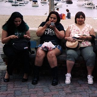 Group of seven people posing together by marina.