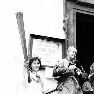 Group performing traditional music outside church entrance.