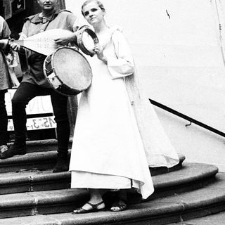 Medieval-themed musicians performing outdoors near entrance.