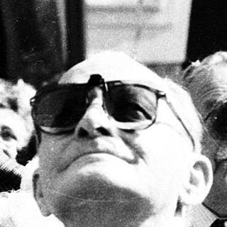 Group of people looking upward at an event.