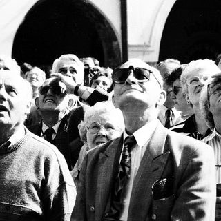 Group of people looking upward at an event.