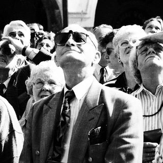 Group of people looking upward at an event.