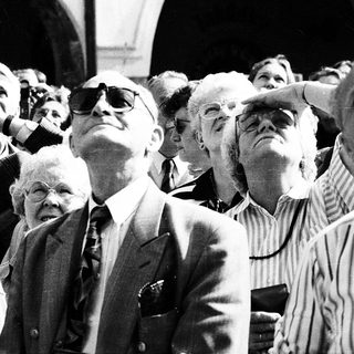 Group of people looking upward at an event.
