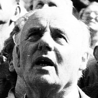 Group of people looking upward at an event.