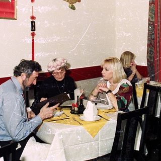 Asian-themed restaurant with patrons dining indoors.