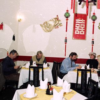 Asian-themed restaurant with diners at tables.