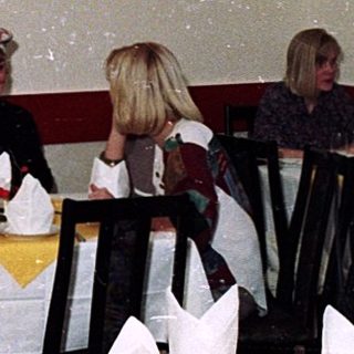 Group dining in festively decorated Chinese restaurant.