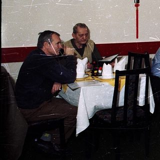 Group dining in festively decorated Chinese restaurant.