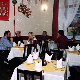 Group dining in festively decorated Chinese restaurant.