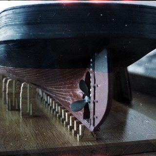Model ship propeller and hull section.