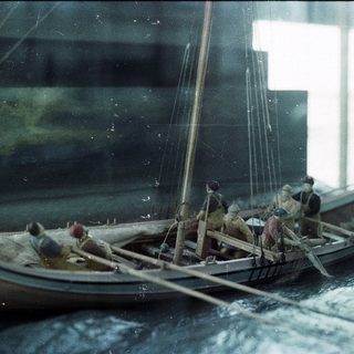 Miniature Viking longship model with crew.