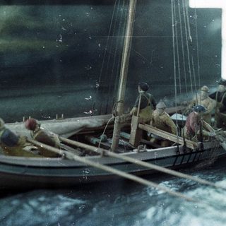 Miniature Viking longship model with crew.