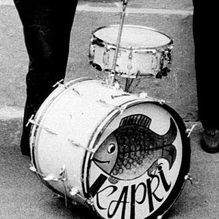 Street band playing instruments outdoors.