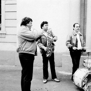 Street band playing instruments outdoors.