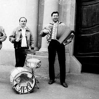 Street band playing instruments outdoors.