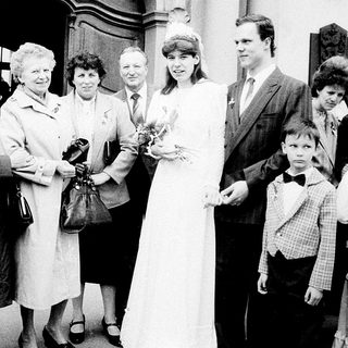 Family gathering at wedding ceremony entrance.