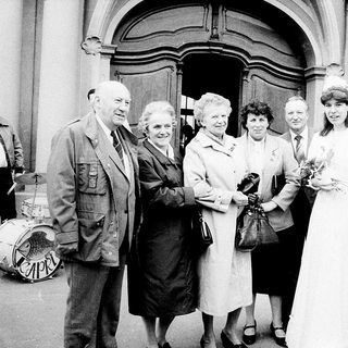 Family gathering at wedding ceremony entrance.
