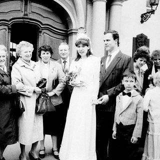 Family gathering at wedding ceremony entrance.