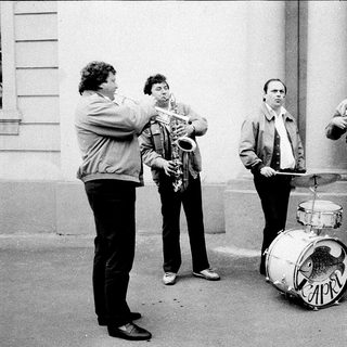 Street band playing instruments outdoors.
