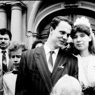 Newlywed couple exiting wedding venue.
