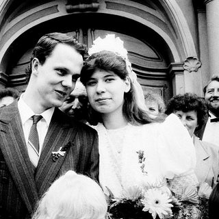 Newlywed couple exiting wedding venue.