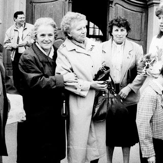 Family gathering outside a church entrance.