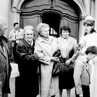 Family gathering outside a church entrance.