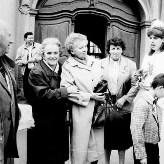 Family gathering outside a church entrance.