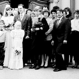 Wedding ceremony group photo outside grand building.