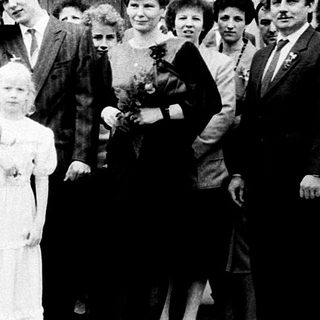 Family wedding ceremony group photo outside church.