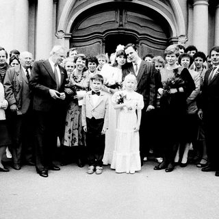 Family wedding ceremony group photo outside church.