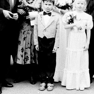 Family wedding ceremony group photo outside church.