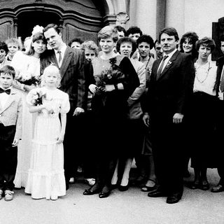 Family wedding ceremony group photo outside church.