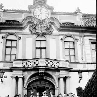 Wedding ceremony at grand historic building entrance.