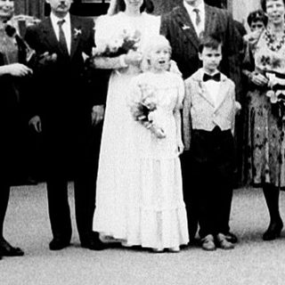 Wedding ceremony at grand historic building entrance.