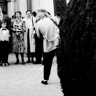 Wedding ceremony at grand historic building entrance.