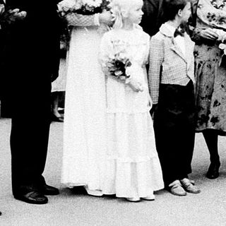 Wedding ceremony guests outside building.