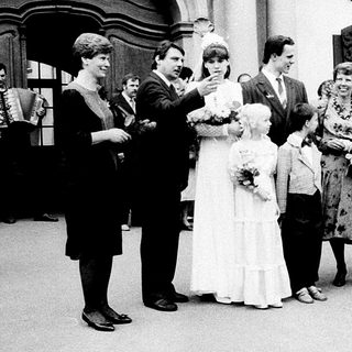 Wedding ceremony guests outside building.