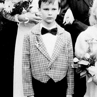Family wedding photoshoot with bride, groom, and children.