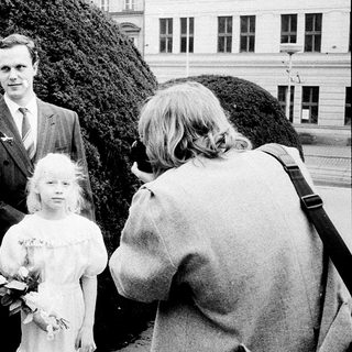 Family wedding photoshoot with bride, groom, and children.