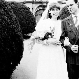 Couple posing on wedding day in formal attire.