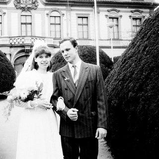 Couple posing on wedding day in formal attire.