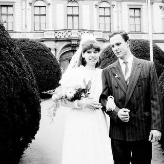 Couple posing on wedding day in formal attire.