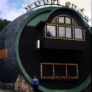 Unique building shaped like a giant tire.