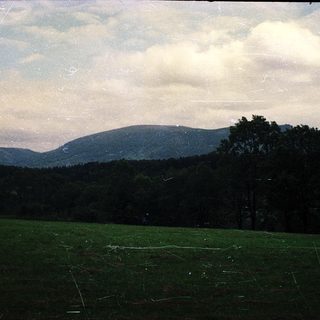 Rural landscape with rolling hills and open fields.