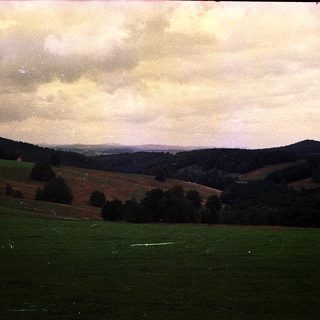 Rural landscape with rolling hills and open fields.