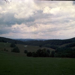 Rural landscape with rolling hills and open fields.
