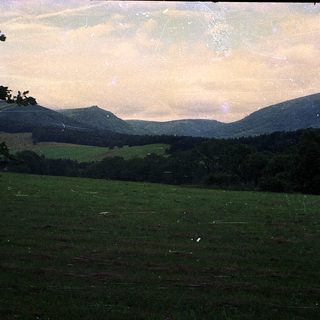 Rural landscape with rolling hills and open fields.
